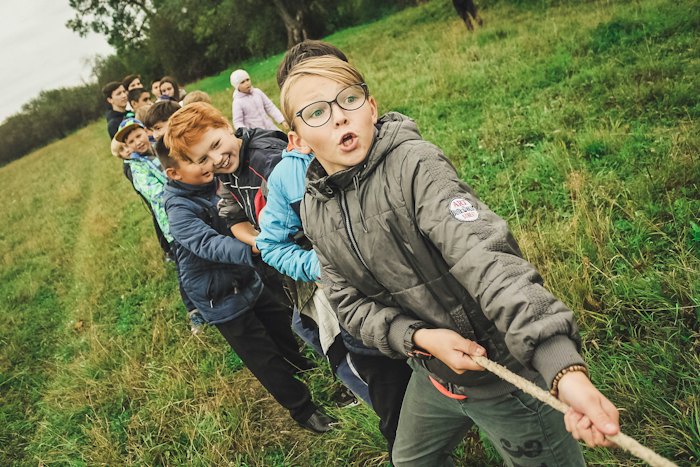 Een groep kinderen trekt samen aan een touw